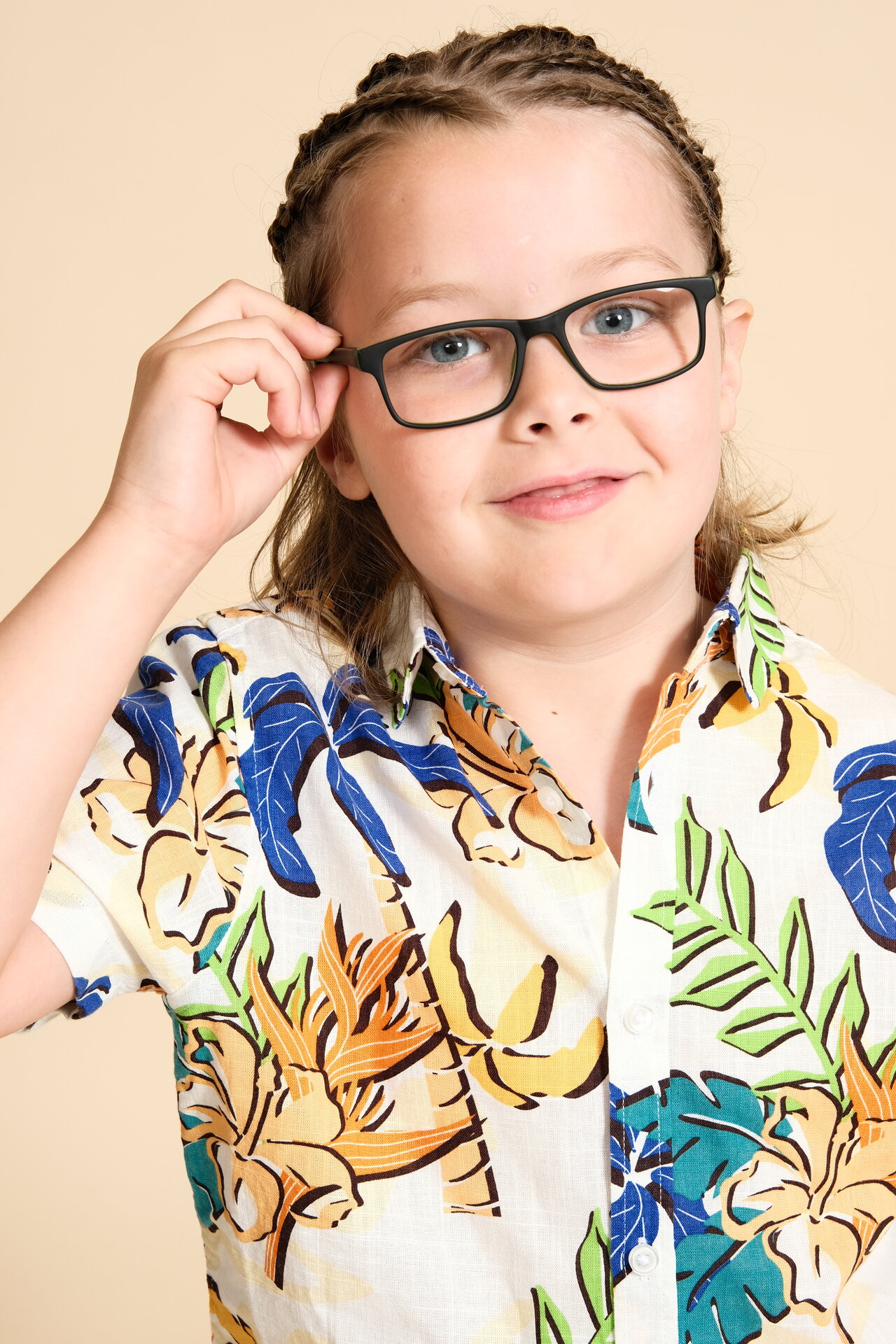 George Rouse three-quarter shot wearing glasses with tropical print shirt, intelligent and approachable look